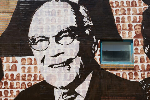 A black and white painting of Dr. Sheldon Korones on the Memphis Upstanders Mural, a painting on a brick wall in Memphis, TN.