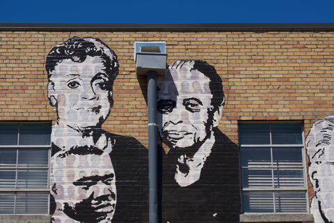 Black and white painting of Maxine and Vasco Smith on the Memphis Upstanders Mural, a painting on a brick wall in Memphis, TN.
