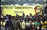 A group of mourners carry a United Democratic Front Banner during a mass funeral.
