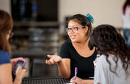 A female student engages in discussion. 