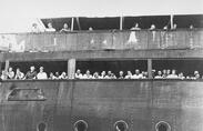 Passengers aboard the St. Louis, seeking refugee from Nazi-occupied Europe, wait to find out if they will be allowed entry into Cuba in June 1939.