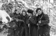 Russian partisans, one of them photographer Faye Schulman, gathering together in the forest, Naliboki Forest, Belarus, December 1944. The Molotava Brigade was a partisan group made up mostly of escaped Soviet Army POWs. The woman pictured is Faye Schulman, a Jewish woman who fled into the Naliboki forest with her camera equipment and joined the Molotova Brigade. For two years in the forest she photographed the partisan's activities, worked as medical aid and participated in the partisans raid's.