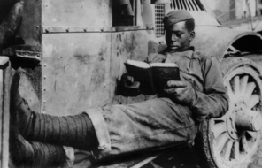 Black Soldier Reading on Truck photo in b&w
