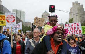 Darnell Taylor marches with his daughter, Lauren, 4, on his shoulders down Market Street to Kiener Plaza as part of a march against police violence downtown St. Louis, Mo., on Saturday, Oct. 11, 2014.  (AP Photo/St. Louis Post-Dispatch, Cristina Fletes-Boutte)