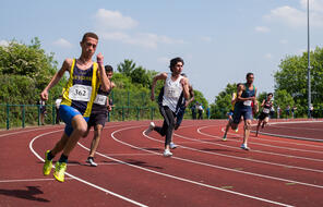 Athletes running on a track.