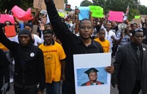 Peaceful protestors march with signs in Ferguson. 