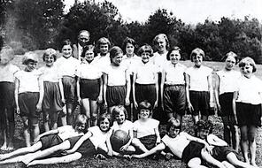 A girl volleyball team poses for a team photo