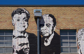 Black and white painting of Maxine and Vasco Smith on the Memphis Upstanders Mural, a painting on a brick wall in Memphis, TN.