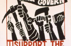 Hands raised in protest hold a book, tools, and paintbrushes carry, and a flag that says "the people shall govern." 