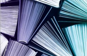 Blue and purple toned books, view from above