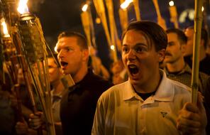 Protesters holding lit tiki torches yell at the Unite the Right rally in Charlottesville, VA in 2017.