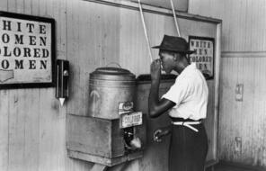 July 1939: An African-American man drinking at a segregated drinking fountain in Oklahoma City, Oklahoma.