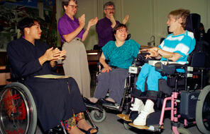 Judy Heumann, center, is applauded during her swearing-in as U.S. Assistant Secretary for Special Education and Rehabilitative Service by Judge Gail Bereola, left, in Berkeley, California, on Tuesday, June 29, 1993