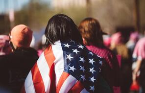  Woman With US Flag On Her Shoulders
