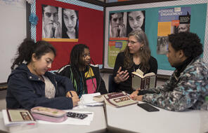 A teacher discusses a reading with her students. 