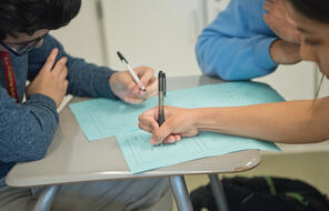 Students work on a written assignment. 