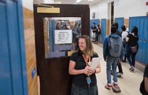 Teacher greeting students in hallway