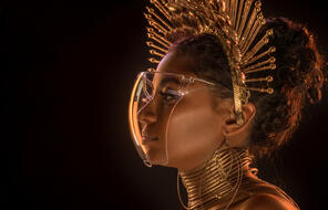 African Woman Wearing Futuristic Face Mask and gold crown