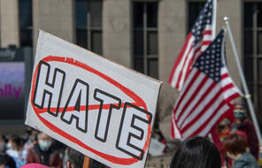 Activist holds a protest sign at Spirit Plaza in the city of Detroit at a Stop Asian Hate rally and march on March 27, 2021