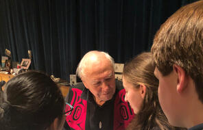 Photograph of Theodore Fontaine engaging with students at an event.