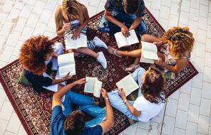 Group of teenagers reading together