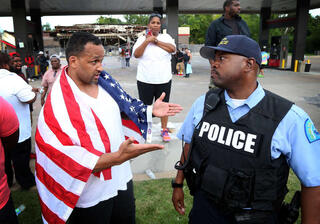 Peaceful protestor speaks to police officer in Ferguson. 