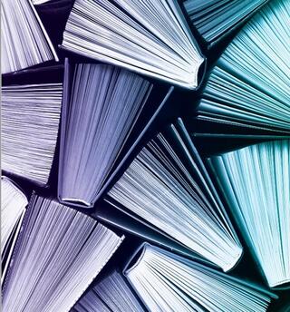 Blue and purple toned books, view from above