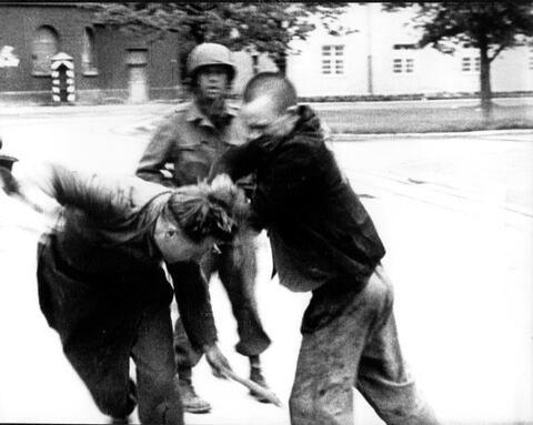  After American soldiers liberated Dachau in 1945, an inmate of the camp attacks a German soldier.