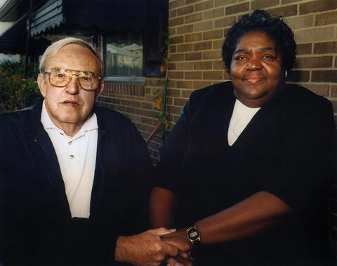 C.J. Ellis, a former Ku Klux Klan member and Ann Water, a community activist, holding hands.