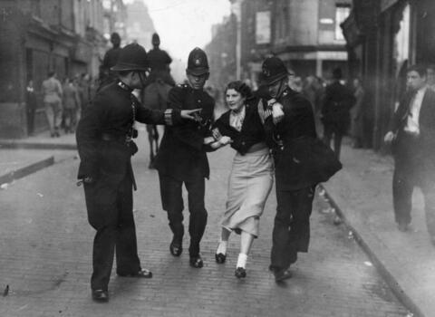 Woman struggling with police as she is arrested for being an anti-fascist