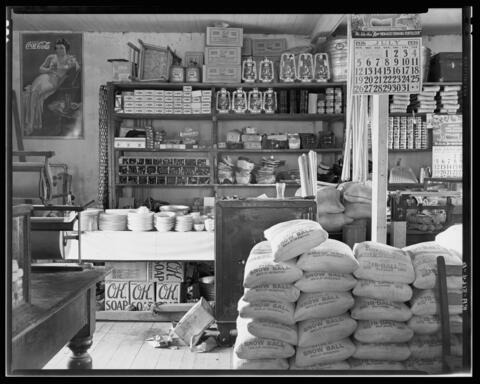 An old country store contains sacks of food and other items for purchase.