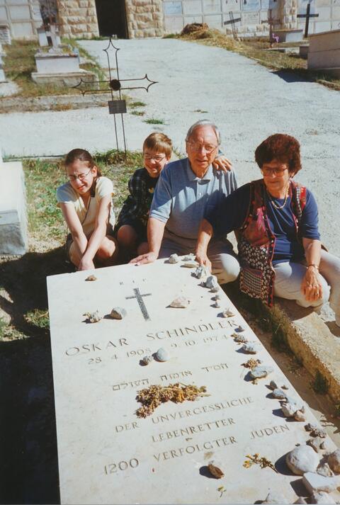 Rena and Mark with their children at the grave of Oskar Schindler 
