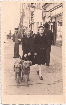Holocaust survivor, Ava Kadishson Schieber (age 11), walks dogs alongside her friend.