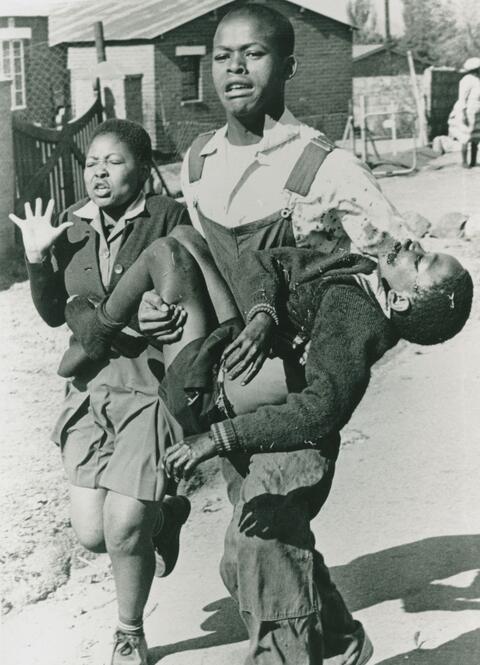 Mbuyisa Makhuba, a black South African young man carries the dead body Hector Pieterson, age thirteen.