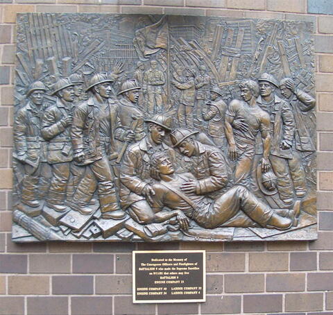 Relief depicting firefighters providing aid on 9/11.