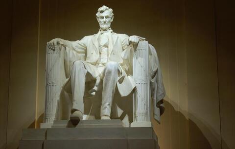 Statue of Lincoln at the Lincoln Memorial at night.