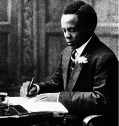 Black and white image of Sol Plaatje writing 
