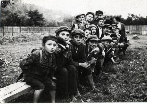 Young boys on a bench in Sighet, Poland. Circa 1920.