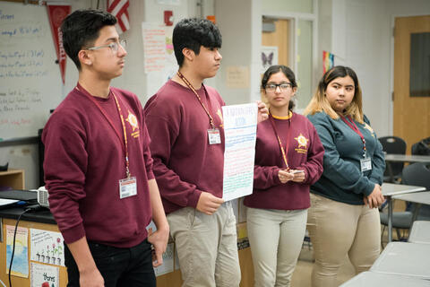 Students present group assignment to class