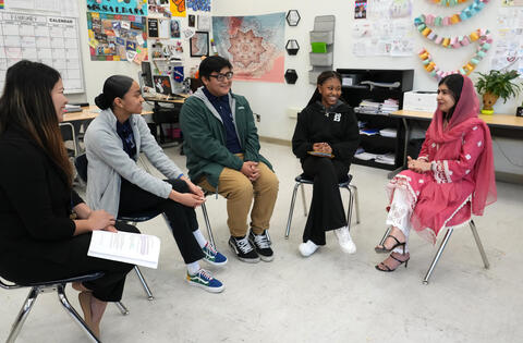 Malala and students have a group discussion.