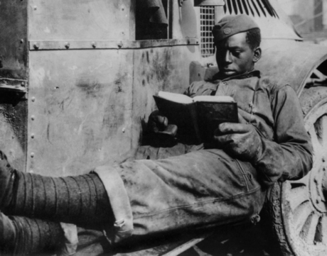 Black Soldier Reading on Truck photo in b&w