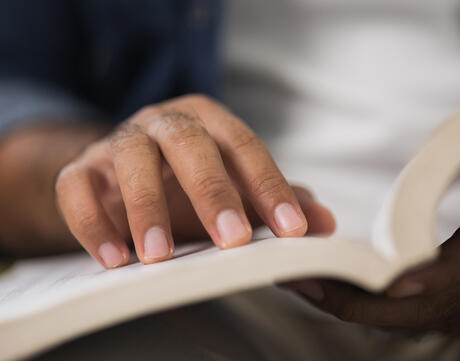 Close up of male hand open book and reading.