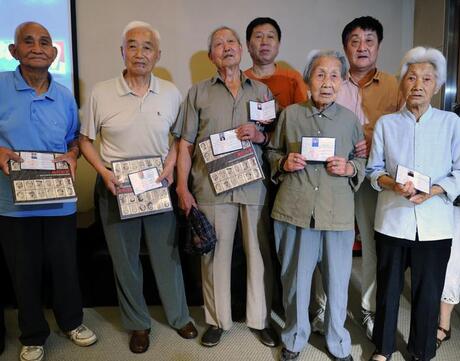 Survivors of the 1937 Nanjing Massacre pose for a photo during a ceremony in Nanjing on July 6, 2013.