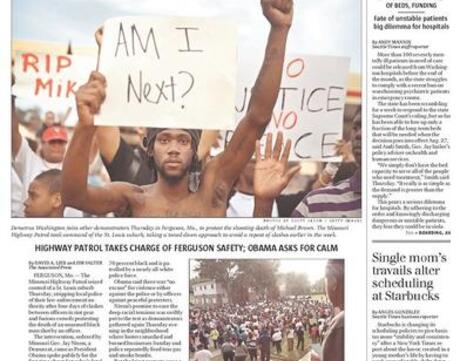 Newspaper front page featuring story about protests and police in Ferguson.