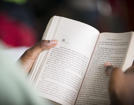 A close-up of an open book in someone's hands