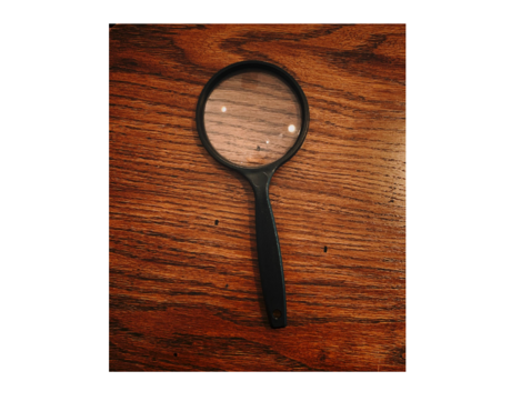 A black-framed magnifying glass