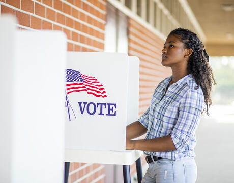 Young women voting at the polls. 