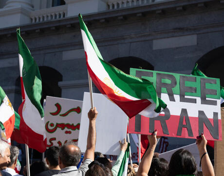 "Free Iran" sign and Iranian flags at Iranian human rights rally - Sacramento, CA