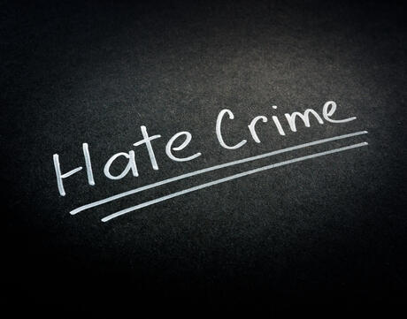 "Hate crime" words on a dark surface
