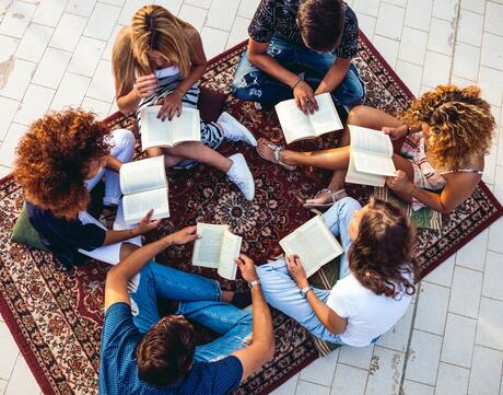 Group of teenagers reading together